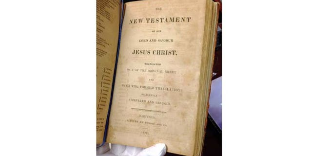 Jan. 12, 2015: In this photo, Texas Supreme Court archivist Tiffany Shopshire shows the 1816 publishing date at the bottom of a page in the Sam Houston Bible, in Austin, Texas. (AP)