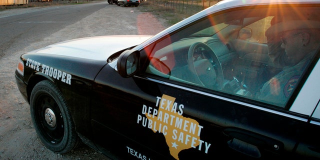 FILE - In this April 6, 2008, file photo, a Texas State Trooper is shown sitting in his vehicle in Eldorado, Texas. Drivers in Texas busted for drunken driving, not paying child support or low-level drug offenses are among thousands of "high-threat" criminal arrests that officials have touted in defense of a nearly $1 billion mission to secure the border with Mexico, an Associated Press analysis has found. (AP Photo/Tony Gutierrez, File)