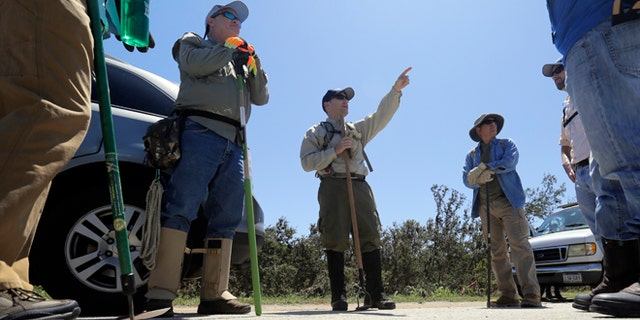 Toby Baker, center, gives directions to a volunteer search team as they prepare to work along the Blanco River, Friday, May 29, 2015, in San Marcos, Texas. Search efforts continue for those persons who went missing from the Memorial Day weekend floods in Central Texas. (AP Photo/Eric Gay)