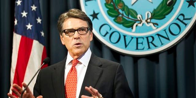 Gov. Rick Perry makes a statement in Austin, Texas on Saturday, Aug. 16, 2014 concerning the indictment on charges of coercion of a public servant and abuse of his official capacity. Perry is the first Texas governor since 1917 to be indicted. (AP Photo/Austin American-Statesman - statesman.com, Laura Skelding)