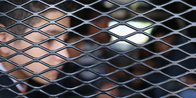 RIO GRANDE CITY, TX - DECEMBER 08: Central American immigrants wait to be transported after turning themselves in to U.S. Border Patrol agents on December 8, 2015 near Rio Grande City, Texas. They had just illegally crossed the U.S.-Mexico border into Texas to seek asylum. The number of migrant families and unaccompanied minors has again surged in recent months, even as the total number of illegal crossings nationwide has gone down over the previous year. (Photo by John Moore/Getty Images)