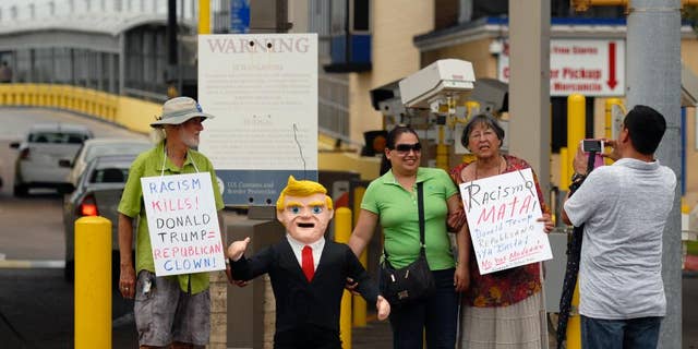 FILE - In this July 31, 2015 file photo, two women pose for a photo standing next to a pinata in the likeness of Donald Trump, during a protest against Trump and derogatory remarks he has made about Mexicans, in Brownsville, Texas. Mexico’s ambassador-designate to Washington, Miguel Basanez, sought to downplay Trump’s comments on Mexico, telling a Senate confirmation hearing on Friday, Aug. 28, 2015, that Trump is simply playing politics. (Brad Doherty/The Brownsville Herald via AP) MANDATORY CREDIT