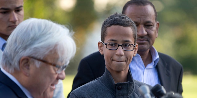 Ahmed Mohamed, second from right, listens as Rep. Mike Honda, D-Calif., left, speaks during a news conference on Capitol Hill in Washington. (AP Photo/Carolyn Kaster)