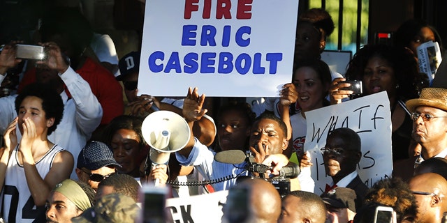 Demonstrators gather near a community pool Monday, June 8, 2015, during a protest in response to an incident at the pool involving McKinney police officers in McKinney, Texas. (AP Photo/Ron Jenkins)