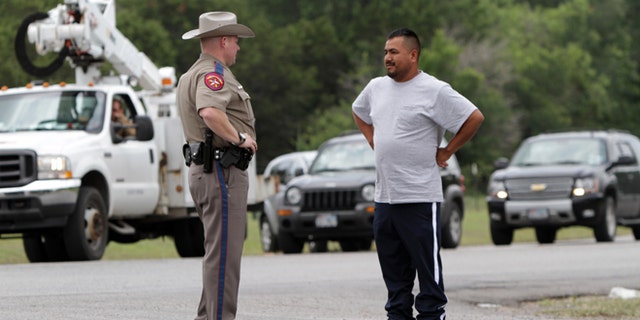Pablo Ramirez, 33, right, speaks to a Texas state trooper on May 16, 2013 in Granbury, Texas.