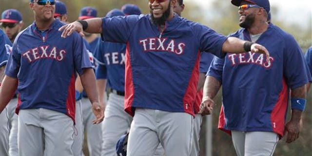 Texas Rangers infielders Adrian Beltre, left, and Prince Fielder, right, are entertained by Elvis Andrus during warm ups at baseball spring training camp in Surprise, Ariz., on Friday, Feb. 21, 2014. (AP Photo/The Fort Worth Star-Telegram, Ron T. Ennis) MAGS OUT; (FORT WORTH WEEKLY, 360 WEST); INTERNET OUT
