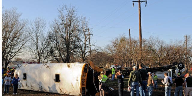 January 17, 2012: Emergency personnel investigate the scene of a wreck where a tractor-trailer clipped a school bus full of students, flipping the bus onto its side and sending 32 people — 29 of them children — to a central Texas hospital in Temple, Texas.