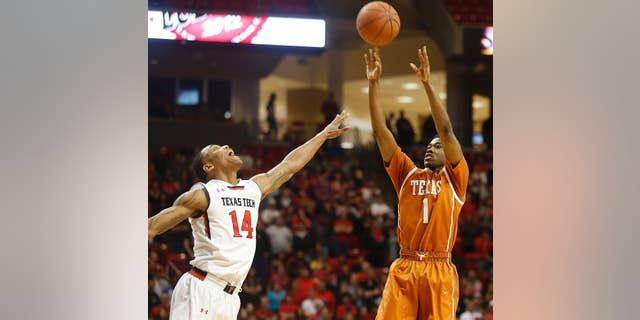 Texas' Isaiah Taylor shoots over Texas Tech's Robert Turner during their NCAA college basketball game in Lubbock, Texas, Saturday, Mar, 8, 2014. (AP Photo/Lubbock Avalanche-Journal, Zach Long) ALL LOCAL TV OUT