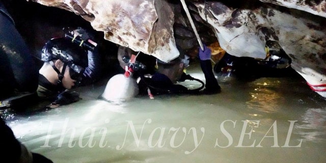 Divers have been taking the boys through dark, tight and twisting passageways filled with muddy water and strong currents.