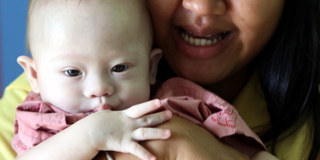 Aug. 3, 2014 - Thai surrogate mother Pattaramon Chanbua, 21, with Gammy, a 9-month old boy born with Down syndrome, at a hospital in Chonburi province, southeastern Thailand. The case of an Australian couple accused of abandoning their baby after discovering he had Down syndrome, has shined light on the unregulated business of commercial surrogacy.