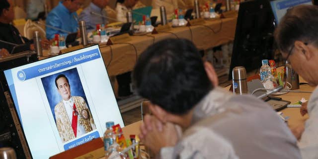 FILE - In this Sept. 9, 2014 photo, a portrait of Thai military junta chief and newly-appointed Prime Minister Gen. Prayuth Chan-ocha is shown on the television screen during the first cabinet meeting at Government House in Bangkok, Thailand. An international human rights group on Thursday, Sept. 11, 2014 called on Thailand's ruling military to end what it says is a "disturbing pattern of repression" in the country since the army seized power in a May coup. (AP Photo/Narong Sangnak, Pool, File)