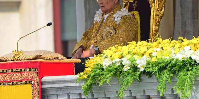 FILE - In this Dec. 5, 2012 file photo, Thai King Bhumibol Adulyadej appears to address a crowd from the balcony at the Anantha Samakhom Throne Hall in Bangkok, Thailand, during his 85th birthday celebration. Thailand's royal palace said in a statement that doctors reported Monday, Sept. 28, 2015, that a blood test and a chest X-ray of King Bhumibol Adulyadej showed that infections detected in early September had cleared up. It said the king's pulse, blood pressure, breathing, blood oxygen level and body temperature were normal.(AP Photo/Sakchai Lalit, File)