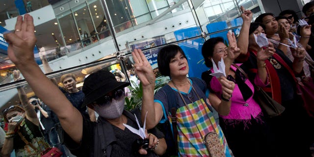 June 1, 2014: Protesters show three fingers represent liberty, brotherhood and equality during an anti-coup demonstration in Bangkok, Thailand. (AP Photo/Sakchai Lalit)