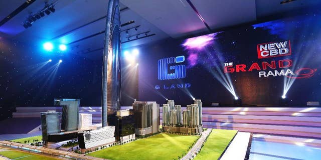 This Oct. 13, 2014 photo released by Grand Canal Land Public Company Ltd. shows a scale model of a skyscraper that a property developer plans to build in Bangkok that will be among the 10 tallest buildings in the world when it is completed in 2019. The 125-floor tower will rise 615 meters (2,018 feet) and include a luxury hotel, offices and an observation deck with panoramic views of the Thai capital, the developer said in a statement. (AP Photo/Grand Canal Land Public Company Ltd.)
