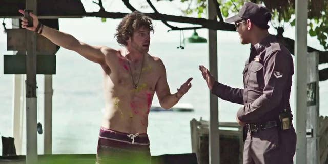In this undated image made from a video produced by the Tourism Authority of Thailand, a fictional British tourist talks to a policeman after losing his bag on a beach in Thailand. A video called "I Hate Thailand," which drew more than 1 million views within days of being posted, turned out to be produced by Thailand's tourism authority, using a strategy of reverse psychology to attract tourists after the country's image was battered by a military coup in May and the brutal murders of two British tourists on an idyllic beach in September. (AP Photo/Tourism Authority of Thailand)