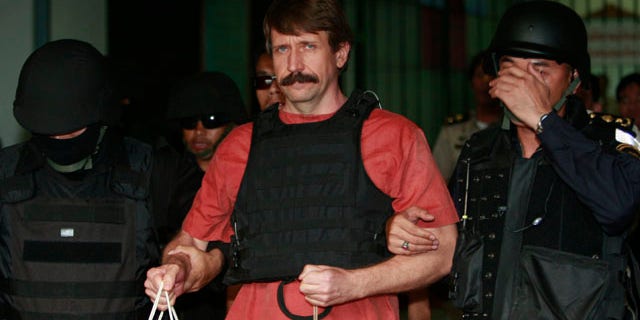 Oct. 4, 2010: With tight security and the flak jacket on, Viktor Bout, center, a suspected Russian arms dealer, leaves the criminal court in Bangkok, Thailand.
