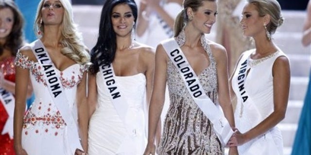 Finalists Morgan Elizabeth Woolard, left, Miss Michigan Rima Fakih, Miss Colorado Jessica Hartman and Miss Virginia Samantha Evelyn Casey react as Hartman is named third runner-up during the Miss USA 2010 pageant Sunday, May 16, 2010 in Las Vegas. Fakih was later crowned Miss USA. (AP Photo/Isaac Brekken)