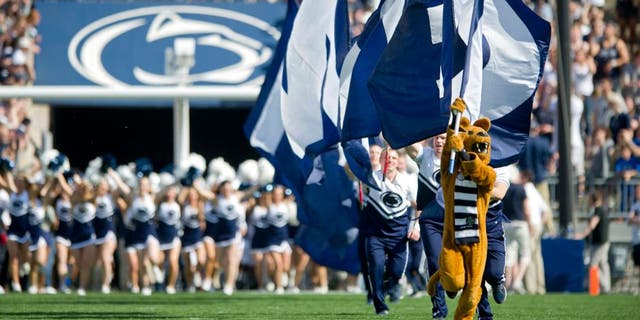 The Penn State Nittany Lion leads the cheerleaders and the football team onto the field for the Blue White game on Saturday, April 18, 2015, at Beaver Stadium in University Park, Pa. (Abby Drey/Centre Daily Times/TNS via Getty Images)