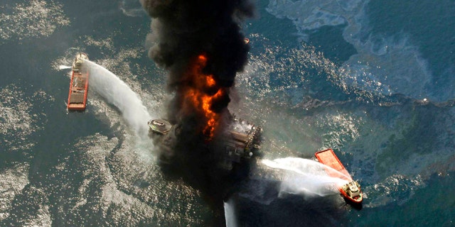 This April 21, 2010, file photo shows the Deepwater Horizon oil rig burning after an explosion in the Gulf of Mexico, off the southeast tip of Louisiana. A new study from the presidential oil spill commission describes the behind-the-scenes, excruiating tension and mistakes behind the three-month effort to cap the busted well.