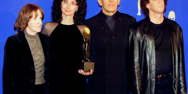The rock group "The Velvet Underground" (R-L) Lou Reed, John Cale, Martha Morrison (wife of Sterling Morrison) and Maureen Tucker, pose for photographers shortly after being inducted in the Rock & Roll Hall of Fame at the eleventh annual Rock & Roll Hale of Fame induction dinner at the Waldorf Astoria Hotel, in New York, January 17 - RTXGAJ2