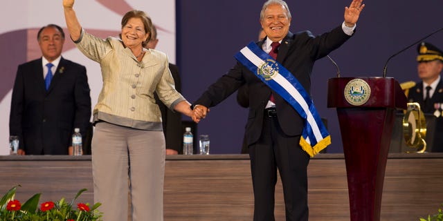 In this June 1, 2014, photo, El Salvador's incoming President, Salvador Sanchez Ceren, right, and his wife Margarita Villalta wave during his swearing in ceremony in San Salvador, El Salvador. (AP Photo/Moises Castillo)