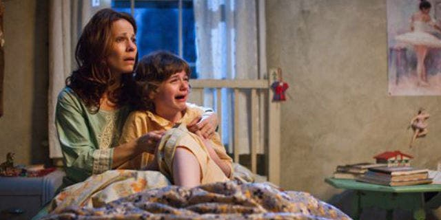 Lili Taylor portrays Carolyn Perron, left, and Joey King portrays Christine in a scene from "The Conjuring."
