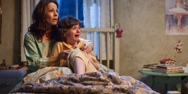 Lili Taylor portrays Carolyn Perron, left, and Joey King portrays Christine in a scene from "The Conjuring."