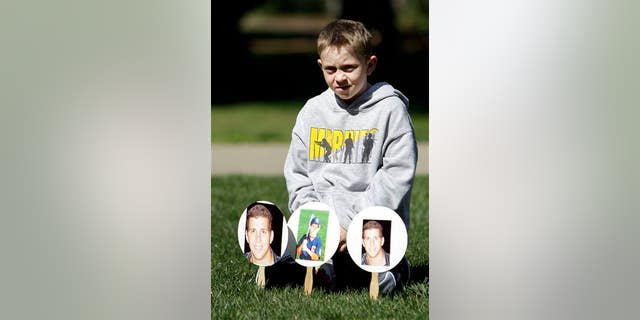 Christopher Hansen sits with photos of his late uncle, Joey Rovero, who died in 2009 after mixing prescription drugs and alcohol. The demonstration was held in Sacramento on Monday, March 11, 2013.