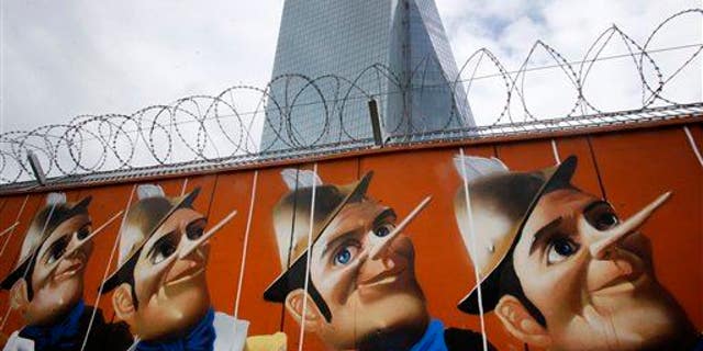 Graffiti is painted on a fence around the construction site of the new HQ of the European Central Bank. The graffiti was created by German street artist Case, who painted 16 Pinocchios.