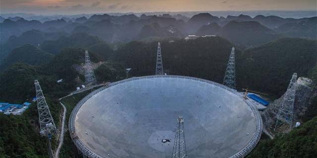The sun sets above the Five-hundred-meter Aperture Spherical Telescope (FAST) in Pingtang County in southwestern China's Guizhou province.