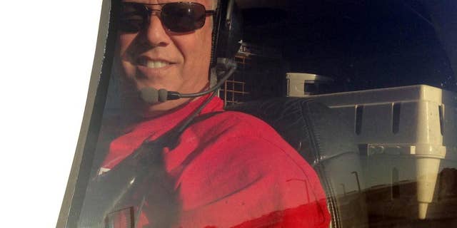 In this Dec. 10, 2014 photo, Jeff Bennett arrives with his 3,000th rescue animal to safety in Tampa, Fla. Bennett flew to the Florida Panhandle and picked up a French bulldog named Reggie, along with several other animals, from shelters and foster homes in Alabama. Bennett has been flying animals from overcrowded shelters to foster homes and vacant shelters for six years. (AP Photo/ Tamara Lush)