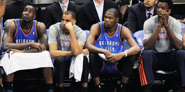 Players on the Oklahoma City Thunder bench sit during the final minutes of Game 1 of a Western Conference finals NBA basketball playoff series against the San Antonio Spurs, Monday, May 19, 2014, in San Antonio. San Antonio won 122-105. (AP Photo/Darren Abate)