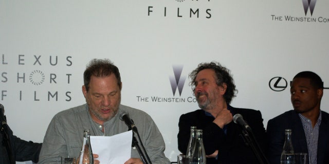Tim Burton and Harvey Weinstein speak at the Cannes Film Festival.