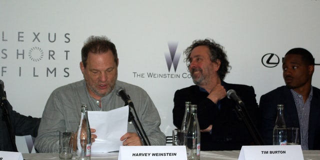 Tim Burton and Harvey Weinstein speak at the Cannes Film Festival.