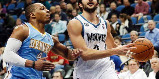 FILE - In this Feb. 12, 2014, file photo, Minnesota Timberwolves' Ricky Rubio, right, of Spain, lays up a shot as Denver Nuggets's Randy Foye defends in the first quarter of an NBA basketball game in Minneapolis. The clock is ticking on the Timberwolves and Rubio to get an extension done. If the two sides don't reach agreement by Oct. 31, Rubio can become a restricted free agent next summer. (AP Photo/Jim Mone, File)