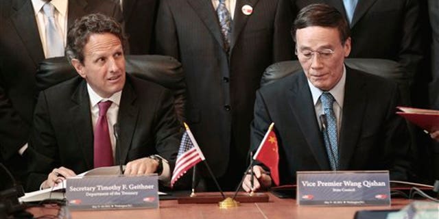 May 10: Treasury Secretary Timothy Geithner and Chinese Vice Premier Wang Qishan take part in a signing ceremony in the Cash Room of the Treasury Department during the US-China Strategic and Economic Dialogue meetings in Washington.