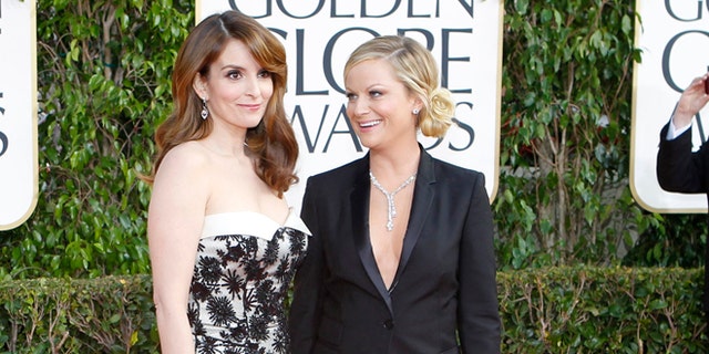 Golden Globe co-hosts, actresses Tina Fey (L) and Amy Poehler, arrive at the 70th annual Golden Globe Awards in Beverly Hills, California, January 13, 2013.