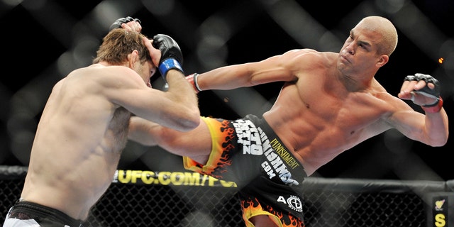 Tito Ortiz (R) battles Forrest Griffin during their Light Heavyweight Fight at the UFC 106 in 2009 in Las Vegas, Nevada.
