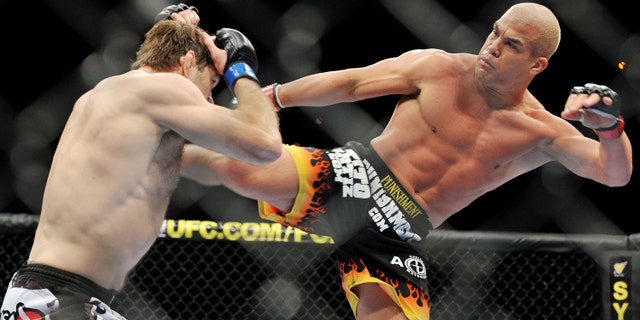 Tito Ortiz (R) battles Forrest Griffin during their Light Heavyweight Fight at the UFC 106 in 2009 in Las Vegas, Nevada.
