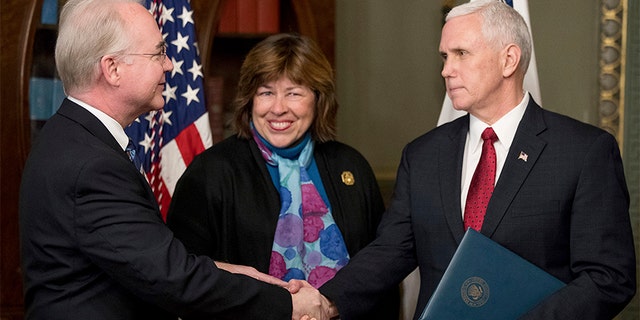 Vice President Mike Pence shakes hands with Health and Human Services Secretary Tom Price, accompanied by his wife Betty, after a swearing-in ceremony, Friday, Feb. 10, 2017, in the in the Eisenhower Executive Office Building on the White House complex in Washington. (AP Photo/Andrew Harnik)