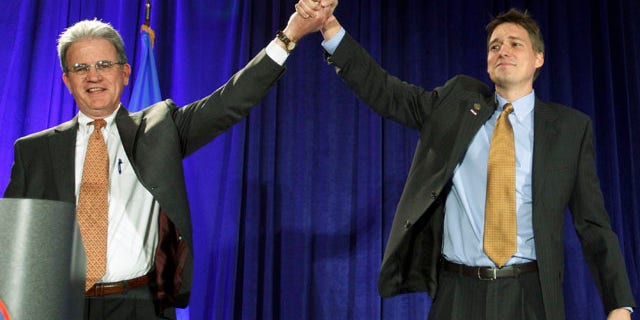 Nov. 2: Matt Pinnell, right, Oklahoma GOP chairman, lifts up the arm of U.S. Senator Tom Coburn, left, at a Republican watch party in Oklahoma City.