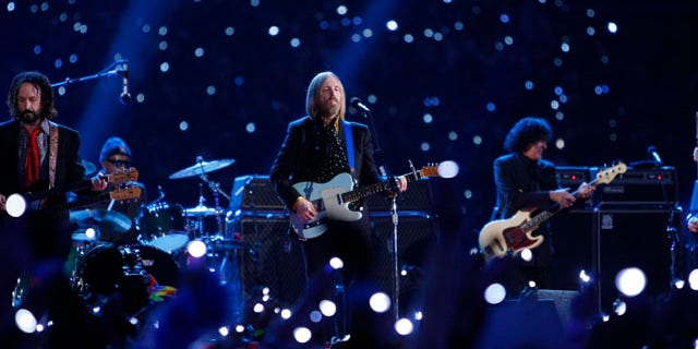 Tom Petty (C) and guitarist Mike Campbell (L) play with the band 'Tom Petty and the Heartbreakers' at halftime of the NFL's Super Bowl XLII football game between the New England Patriots and the New York Giants in Glendale, Arizona February 3, 2008. REUTERS/Mike Blake (UNITED STATES)