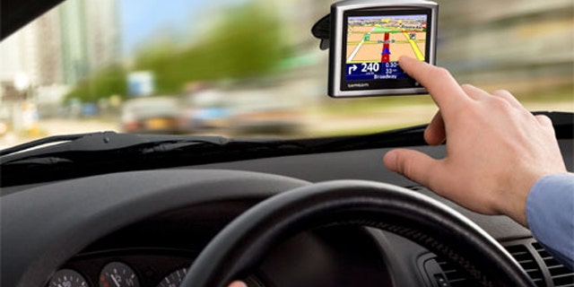 A windshield-mounted GPS helps a driver navigate.