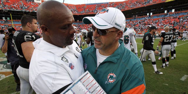 December 4, 2011: Oakland Raiders head coach Hue Jackson, left, and Miami Dolphins head coach Tony Sparano congratulate each other after the Dolphins defeated the Raiders 34-14 in an NFL football in Miami.