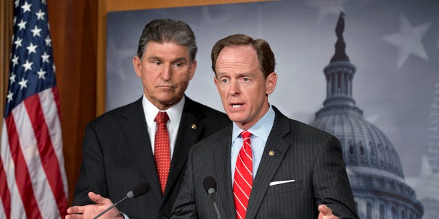 Sen. Joe Manchin, D-W.V., left, and Patrick Toomey, R-Pa., announce a deal on gun-control legislation, on Capitol Hill, in Washington, D.C.