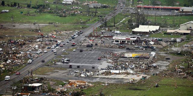 FILE - This Monday, April 28, 2014 aerial photo shows destroyed buildings and debris along U.S. Highway 64 in Vilonia, Ark. Vilonia was hit hard Sunday for the second time in three years. Four people were killed in a 2011 storm. Until this late April 2014 outbreak, the U.S. as a whole had by far the quietest start of the year for tornadoes. Longer trends show more tornado clusters recently. (AP Photo/Danny Johnston)