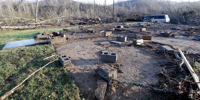 Concrete blocks from the foundation of the home of Antonio Yzaguirre, and his wife, Ann Yzaguirre, show where the house once stood, Thursday, Dec. 24, 2015, after severe storms went through the area Wednesday night near Linden, Tenn. The couple was killed in the storm. (AP Photo/Mark Humphrey)