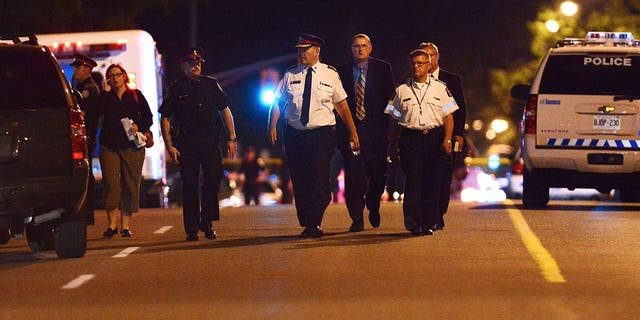 July 17, 2012: Toronto Police Chief Bill Blair walks down Morningside Ave. in Toronto following a shooting that left at least 19 people injured and two dead at a house party.