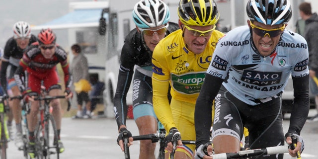 Saxo Bank rider Alberto Contador of Spain (R) cycles ahead of Europcar rider and race leader Thomas Voeckler of France (2nd R) and Leopard rider Andy Schleck of Luxembourg (C), BMC rider Cadel Evans of Australia (2L) and Leopard rider Frank Schleck of Luxembourg (L) during the 16th stage from Saint-Paul-Trois-Chateaux to Gap at the Tour de France 2011 cycling race July 19, 2011.