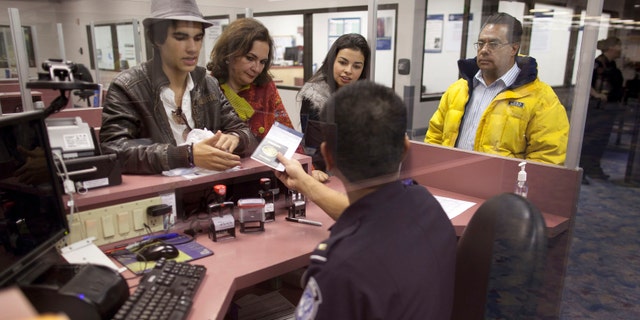 Non-resident visitors to the United States have their passports checked at immigration control after arriving at McCarran International Airport, Tuesday, Dec. 13, 2011, in Las Vegas. The U.S. Travel Association is pushing Congress to make it easier for foreigners to visit the United States. Nearly 7.6 million nonimmigrant visas were issued in 2001, compared to fewer than 6.5 million in 2010. (AP Photo/Julie Jacobson)
